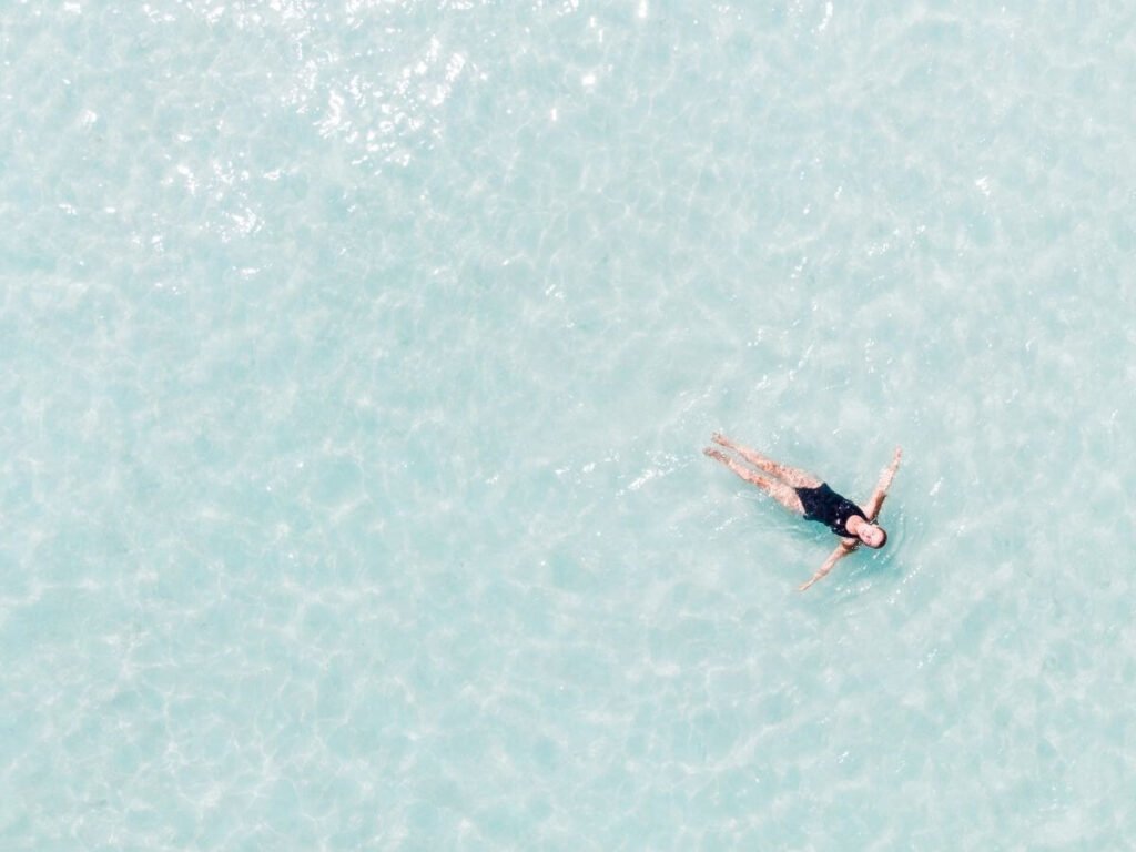 Image of a woman floating on an empty pool